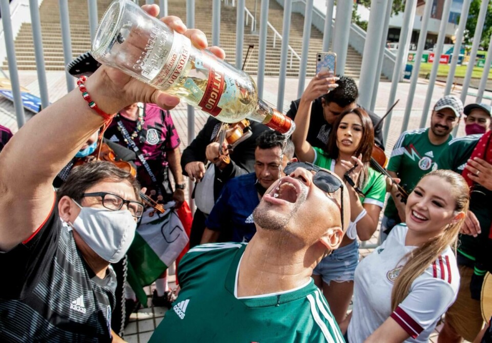 Meksikanske fotballfans bør la tequilaen bli igjen hjemme når de tar turen til Qatar i november. Her drikkes det tequila før kampen mellom Mexico og San Jose i september 2021. Foto: Ezequiel Becerra /AFP